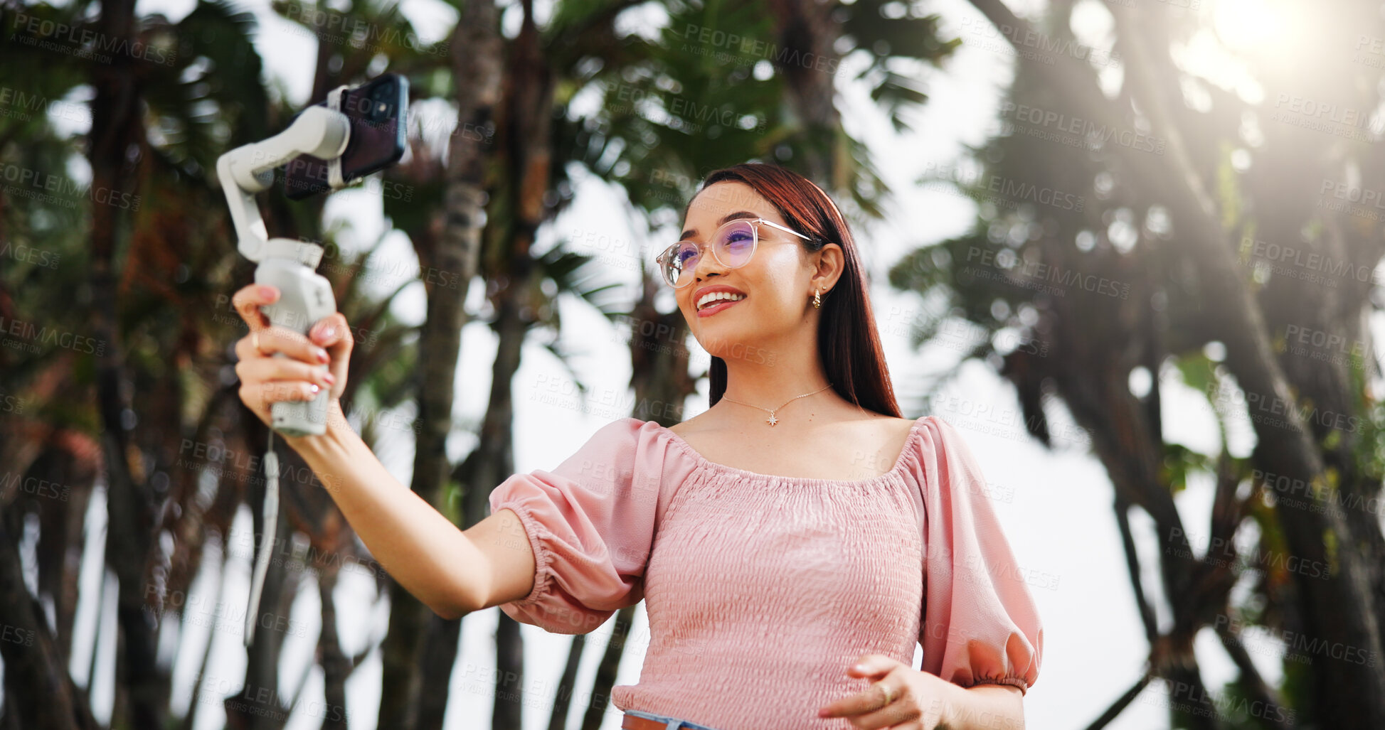 Buy stock photo Phone gimbal, live streaming and woman outdoor for travel, vlog and tourism review. Mobile, smile and influencer at park for recording video, social media and broadcast on holiday with low angle