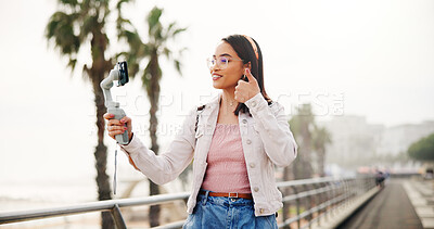 Buy stock photo Selfie stick, live streaming and woman with thumbs up outdoor for travel, vlog and tourism review. Like hand gesture, smile and influencer in city for social media photo on holiday with internet fans