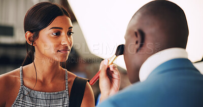 Buy stock photo Production studio, woman and makeup application for beauty, touch up and preparation. Behind the scenes, cosmetics and man getting ready with artist for fashion shoot with brush to apply foundation