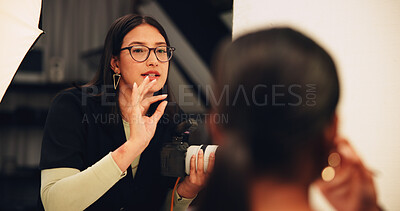 Buy stock photo Woman, photographer and explain to model in studio for photoshoot, pose advice and feedback. Female person, equipment and backstage with camera, capture image and planning for film production on set