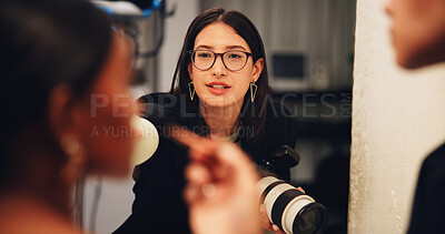 Buy stock photo Makeup, photography and styling with people in studio together, getting ready for session or shoot. Behind the scenes, direction or talking with photographer, stylist and talent on production set