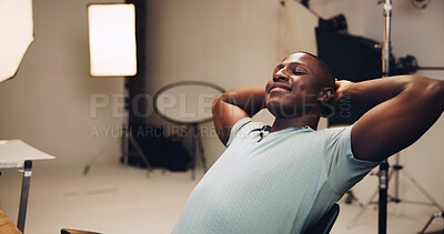 Buy stock photo Photography, smile and relax with black man in studio for photoshoot, satisfaction and retouching. Happy, production process and calm with male person on set for peace, backstage and media shooting
