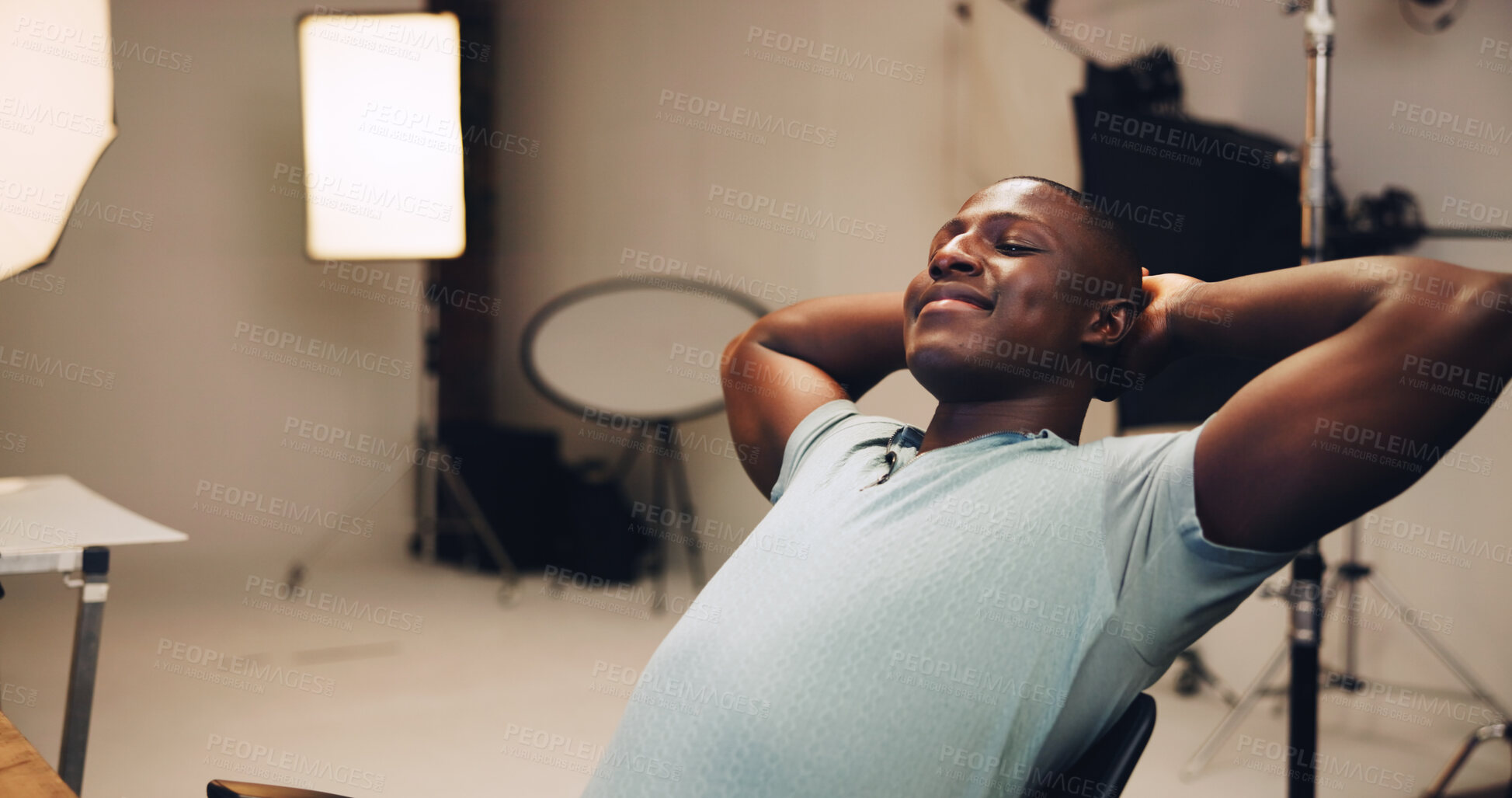Buy stock photo Photography, smile and relax with black man in studio for photoshoot, satisfaction and retouching. Happy, production process and calm with male person on set for peace, backstage and media shooting