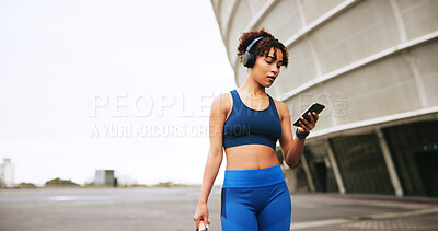 Buy stock photo Mobile, fitness and woman in city with music for exercise, streaming podcast or radio online. Phone, athlete and listening to headphones outdoor for workout audio, mockup space and walking with bag