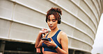 Phone, fitness and woman in city with music for exercise, streaming podcast or radio online. Mobile, athlete and listening to headphones outdoor for post workout song, audio and walking with bag