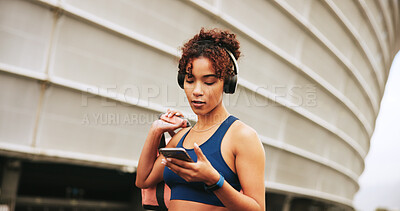 Buy stock photo Phone, fitness and woman in city with music for exercise, streaming podcast or radio online. Mobile, athlete and listening to headphones outdoor for post workout song, audio and walking with bag