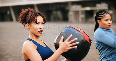 Buy stock photo Exercise, medicine ball and teamwork with women in city for challenge, workout and performance. Health, wellness and commitment with friends outdoor for training partner, fitness club and sports