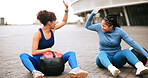 Fitness, workout and women with high five in city for strength training, teamwork or performance. Ground, friends or celebration with medicine ball for exercise support, achievement or wellness goals