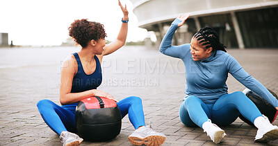 Buy stock photo Fitness, workout and women with high five in city for strength training, teamwork or performance. Ground, friends or celebration with medicine ball for exercise support, achievement or wellness goals