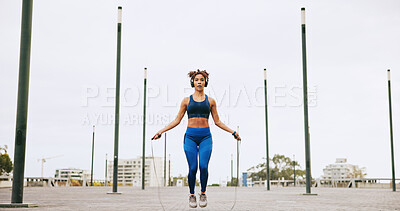 Buy stock photo Fitness, skipping and woman in city for exercise, activity or challenge for weight loss outdoor. Sports, energy and female athlete with jump rope for cardio workout or training for health in town.
