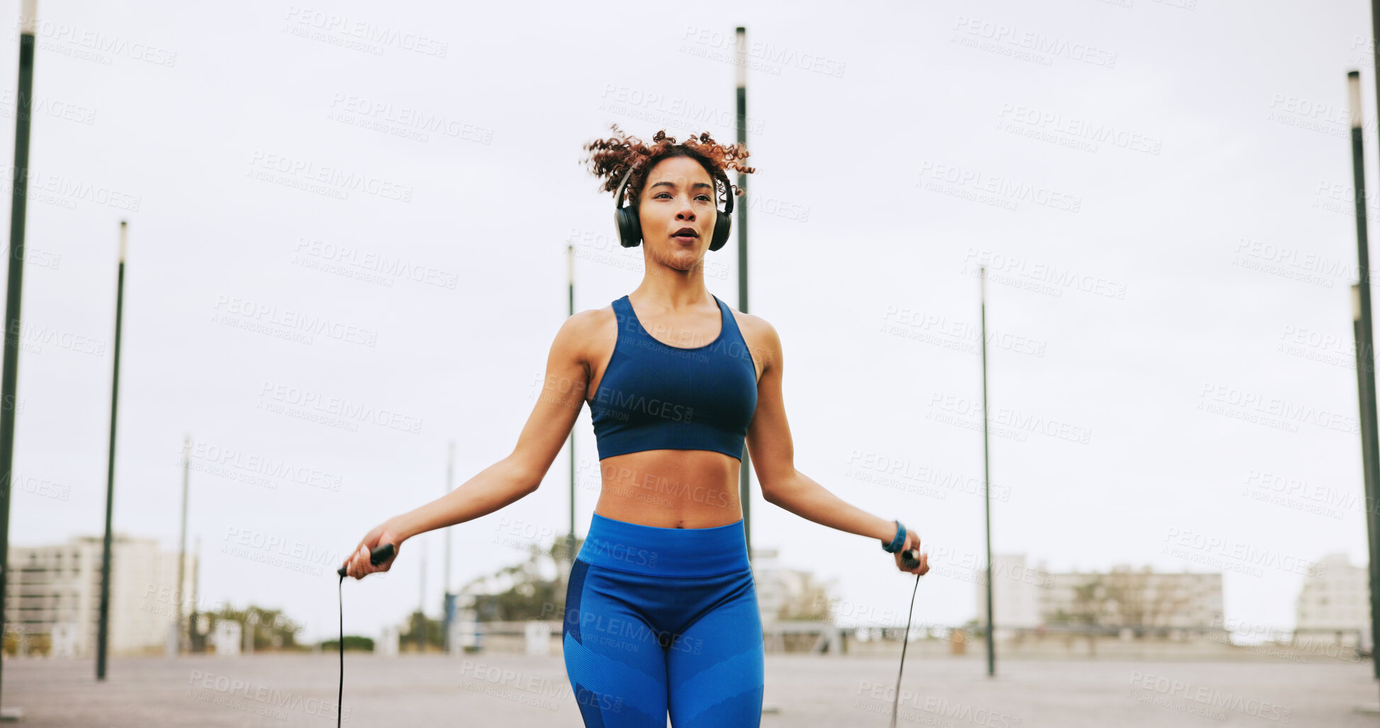 Buy stock photo Sports, skipping and woman in city for exercise, activity or challenge to lose weight outdoor. Fitness, energy and female athlete with jump rope for cardio workout or training for health in town.