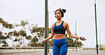 Fitness, skipping and woman in city for workout, activity or challenge for weightloss outdoor. Sports, energy and female athlete with jump rope for cardio exercise or training for health in town.