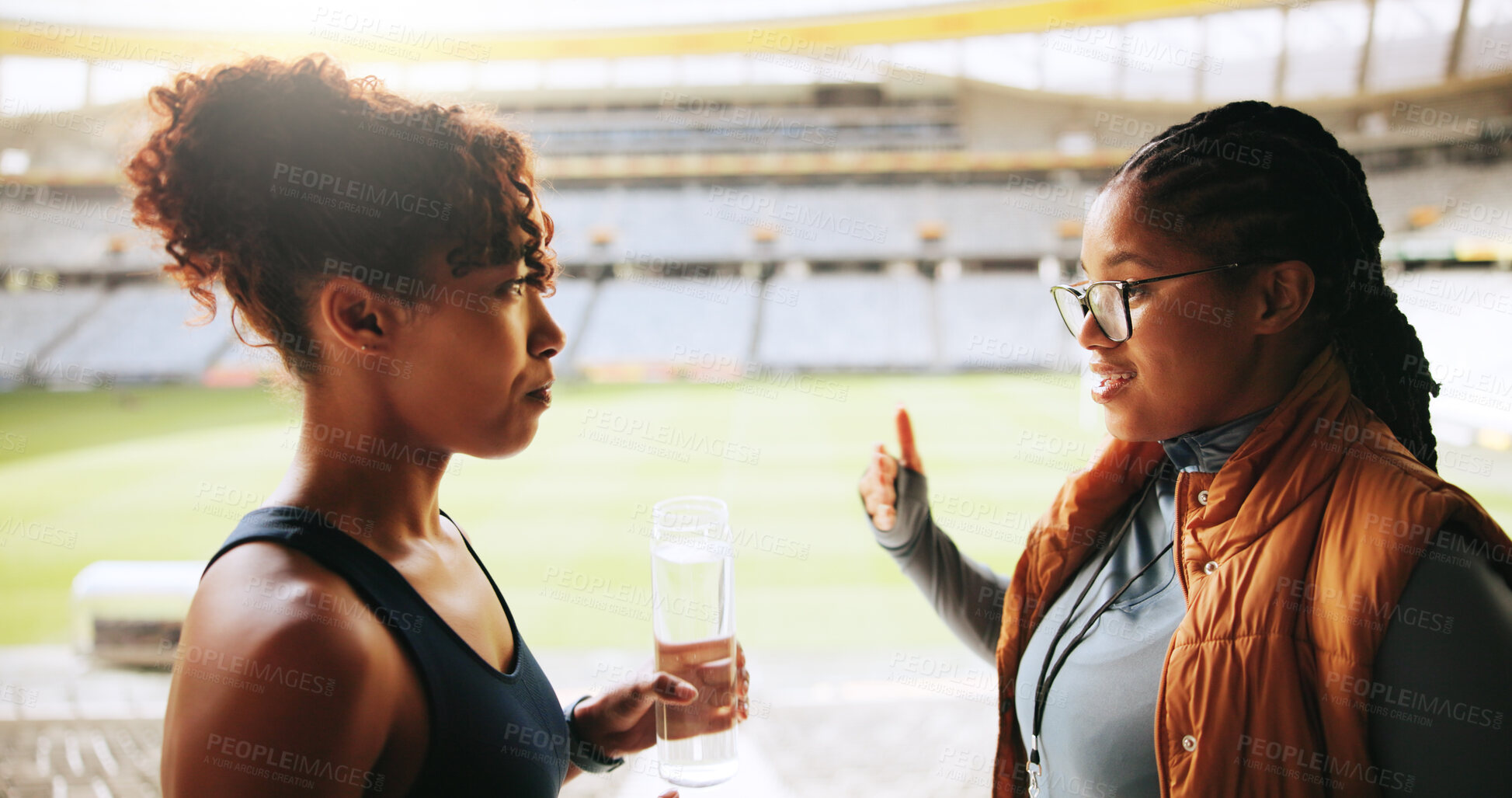 Buy stock photo Women, sports coach and player with discussion, advice and feedback with training. People, personal trainer and professional athlete with help, fitness and outdoor stadium with schedule and support