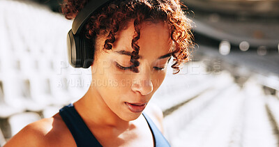 Buy stock photo Breathing, exercise and music with woman outdoor in stadium for break, recovery or rest from training. Fatigue, fitness and headphones with tired athlete at venue for competition, sports or workout