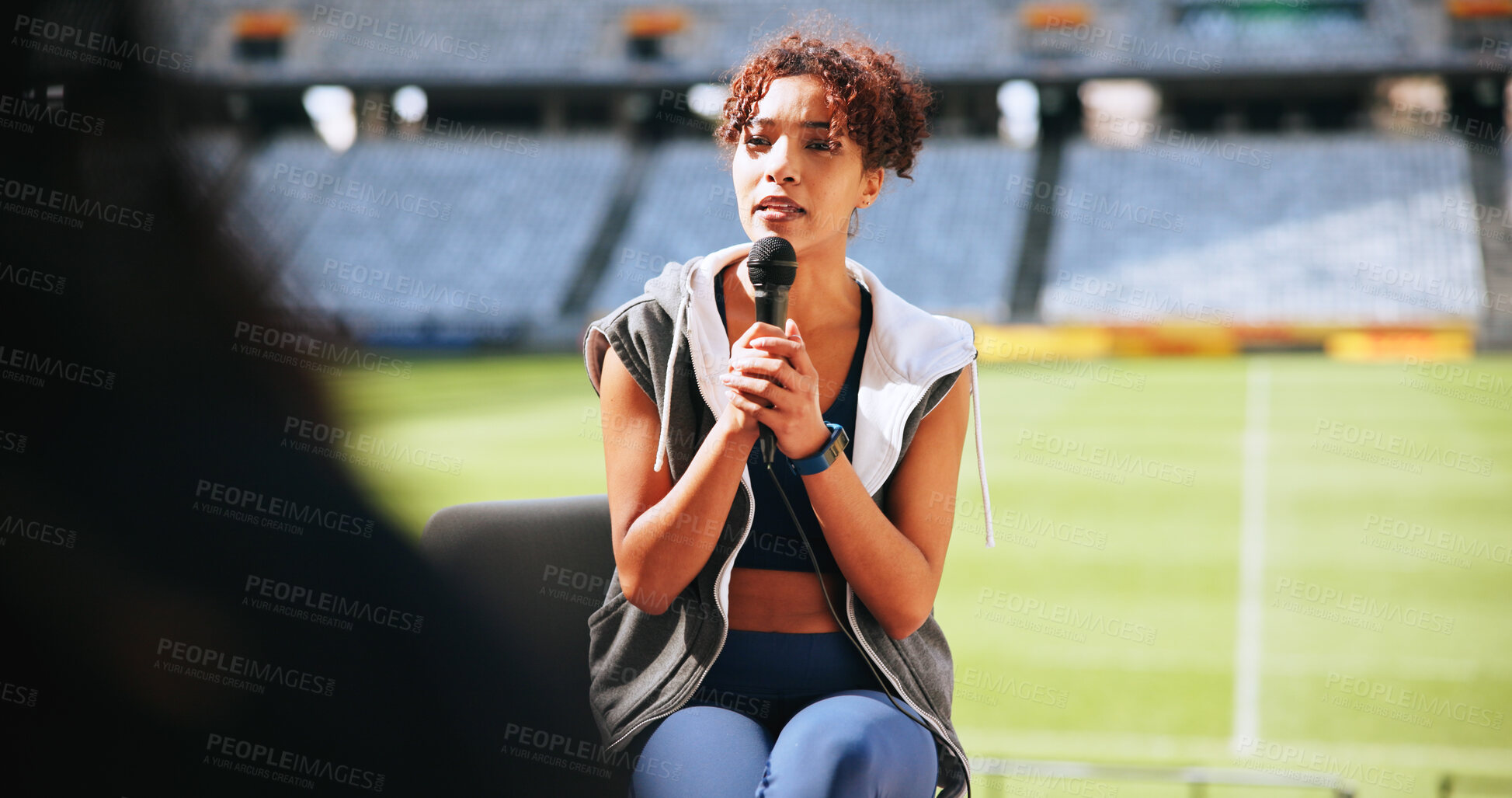 Buy stock photo Athlete, mic and woman in interview at stadium for sports broadcast, media question or game update. Public relations, news and person speaking at press conference for fitness event and fan engagement