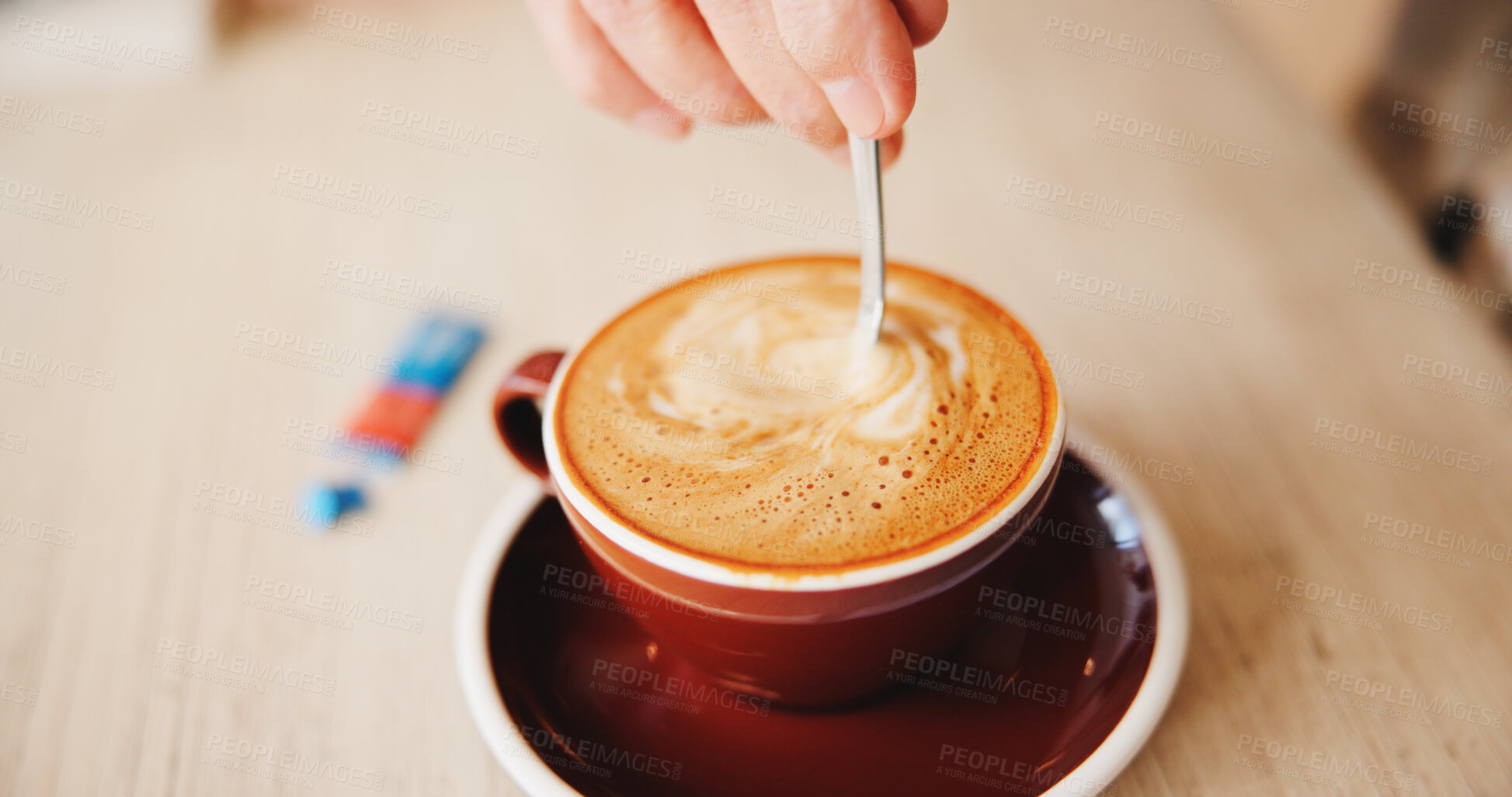 Buy stock photo Table, hands and stir cappuccino in restaurant for caffeine, prepare beverage and warm drink. Above, person and mixing sugar in cafe for coffee sweetener, espresso break and routine to enhance flavor