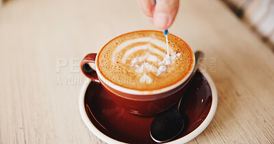 Buy stock photo Table, hands and sugar in cappuccino at restaurant for caffeine, prepare beverage and warm drink. Diner, person and sachet for coffee sweetener, espresso break and morning routine to enhance flavor