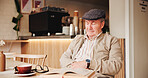 Sleeping, book and senior man in coffee shop with fatigue, exhaustion or tired for morning. Cappuccino, resting and elderly male person in retirement with afternoon nap in cafe, restaurant or bistro.