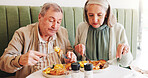 Eating, breakfast or senior couple in cafe on date together in retirement for love, eggs or food. Taste, hungry or elderly people in restaurant with lunch and care at diner for romantic anniversary