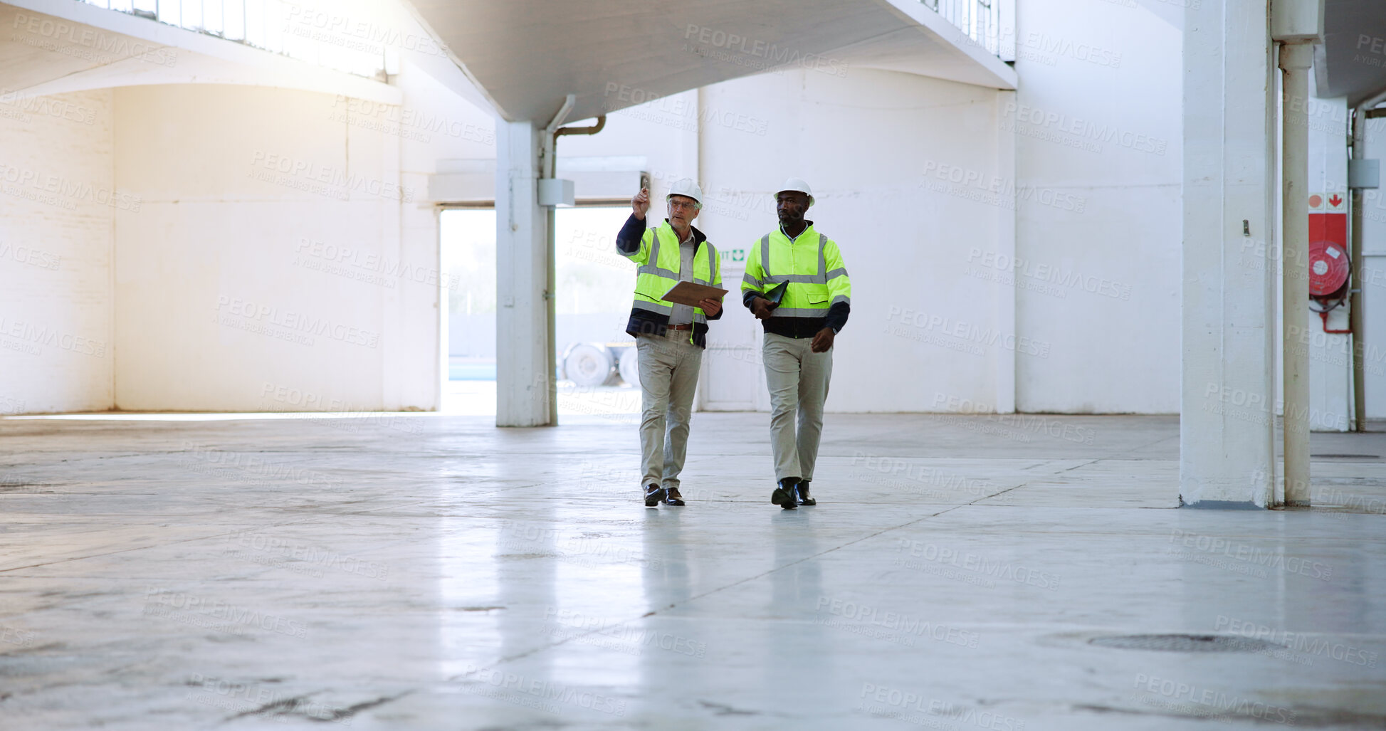 Buy stock photo Men, architect and discussion with clipboard at warehouse, point or report at distribution center. People, mentor and building inspector with safety check at plant for cargo, freight and planning