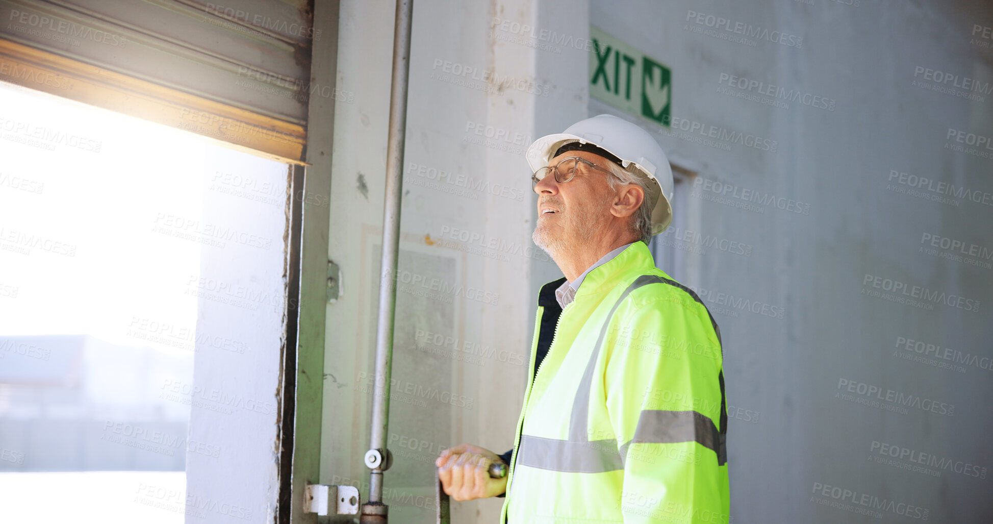 Buy stock photo Mature man, garage door and open at warehouse with maintenance, gear and security check. Person, engineer and architect with building inspection for gate, thinking or contractor with smile at factory