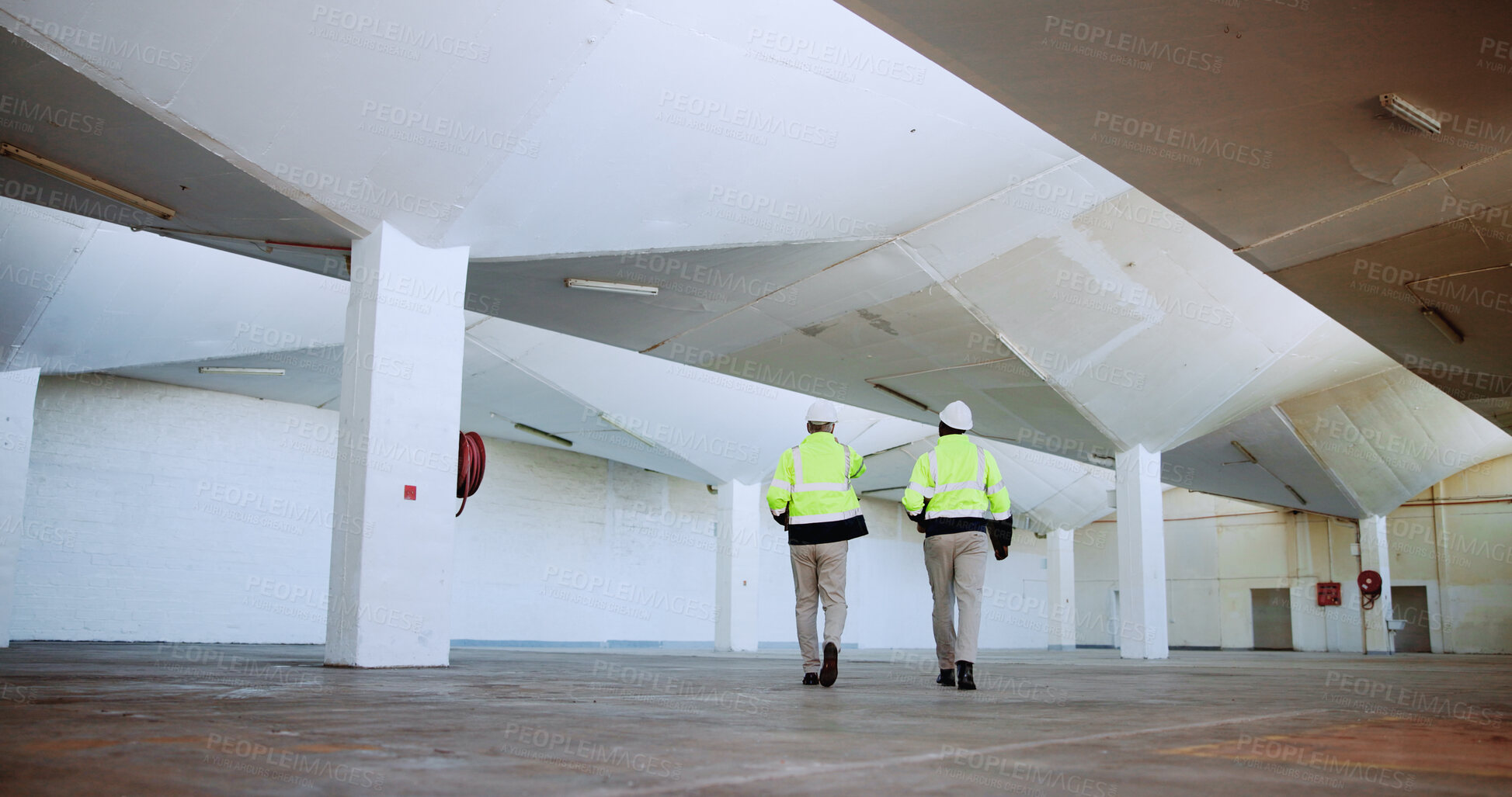 Buy stock photo Men, architect and inspection with point at warehouse, talk and review for design at plant. People, mentor and engineer with safety check for planning, expansion and feedback at construction site