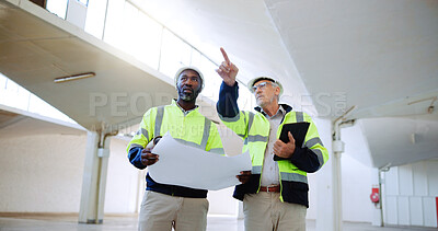 Buy stock photo Construction, pointing and men with blueprint in building for collaboration, project ideas and renovation. Engineering, architecture team and people with documents for floor plan, layout and design