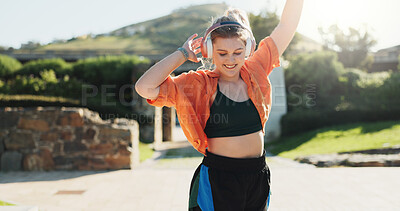 Buy stock photo Fashion, dancing and woman at park with music for energy, freedom and streaming radio song. Listening to headphones, smile and dancer outdoor for hip hop, audio and sound with stylish streetwear