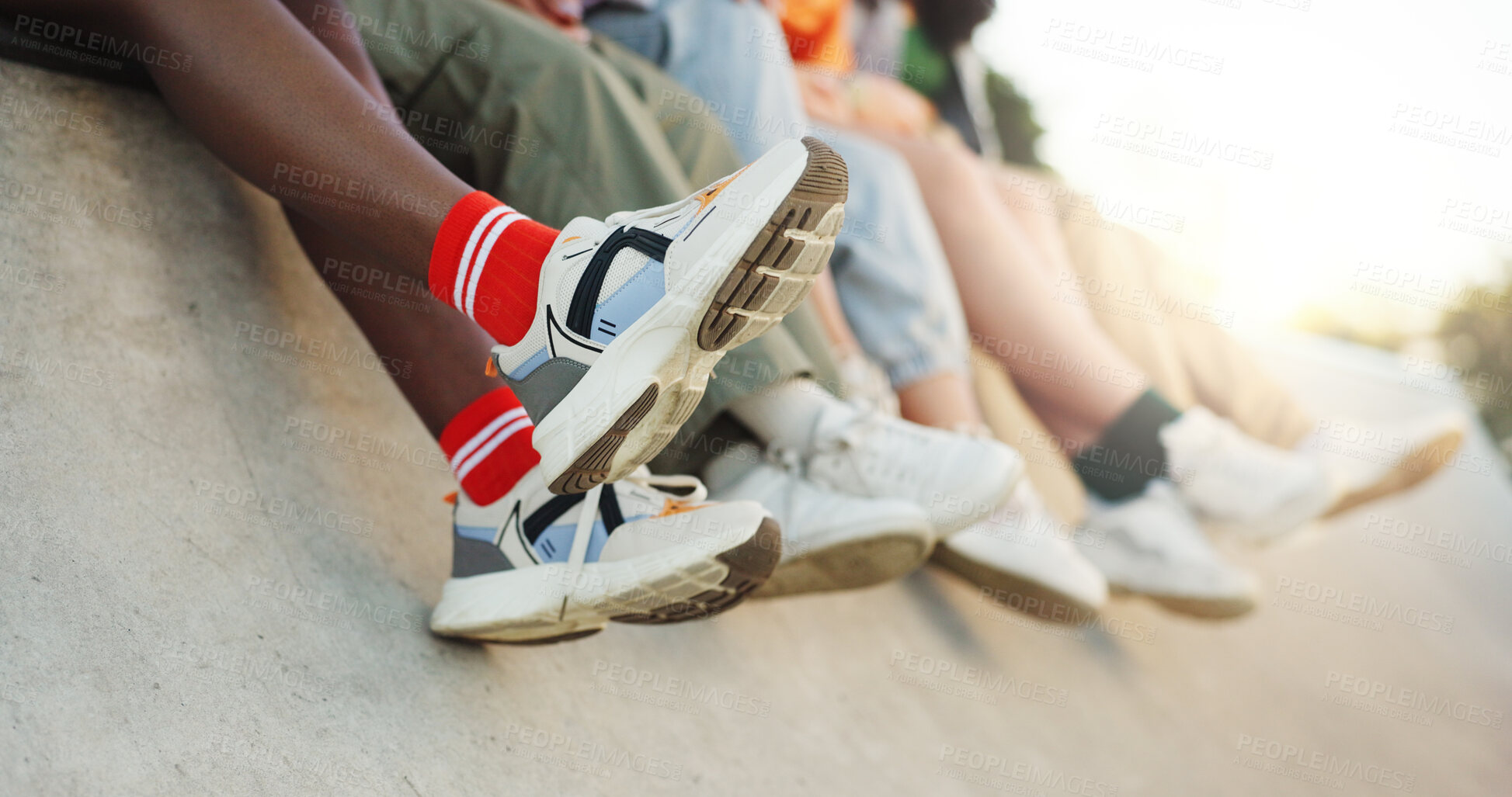 Buy stock photo Legs, group and shoes of friends in city for fashion, youth culture and creative streetwear. Urban, relax or people with sneakers in park for cool footwear, trendy style or outdoor break to chill