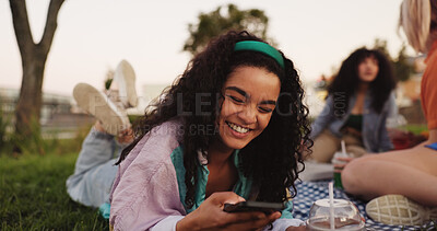 Buy stock photo Texting, woman and smartphone on picnic, smile or communication with contact on social media or app. Friends, reunion and happy with chat on website, people and message with mobile, outdoor or typing