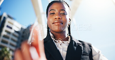 Buy stock photo Business woman, smile and selfie outdoor with point, low angle and post on web with commute to work. African person, POV and portrait in city for social media, pride and profile picture in Nigeria