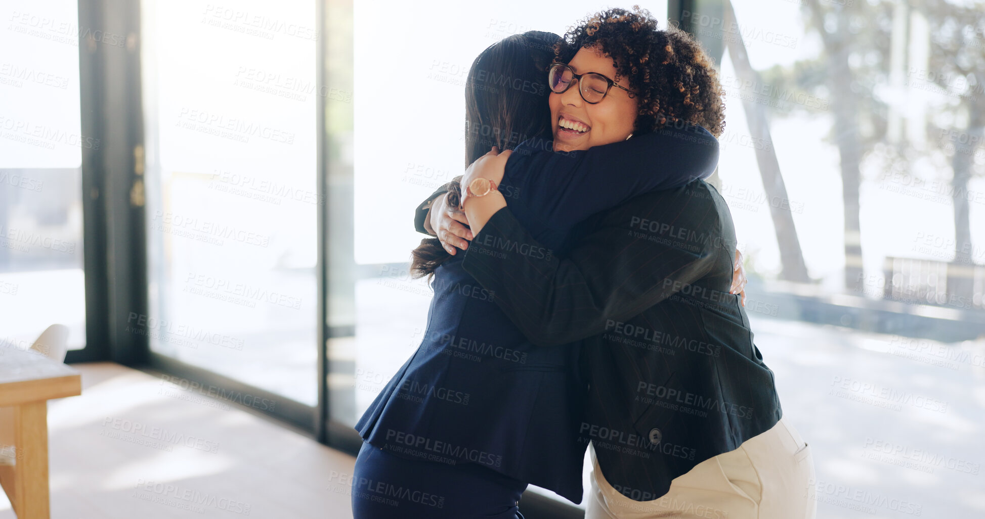 Buy stock photo Business women, hug and smile at office for success, promotion or congratulations for achievement. People, employee and friends with embrace, thanks and happy with goals by window at insurance agency