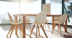 Empty office, table and chairs for workplace interior with architecture, window and background. Boardroom, furniture and flare in meeting room, workspace and whiteboard for presentation at company