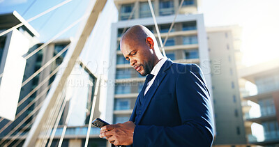 Buy stock photo Corporate, phone and business black man in city for networking, contact and online connection. Reading, professional and person typing on smartphone for website, internet news and email in urban town