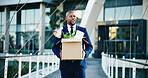 Black man, leaving and business with box for new career, job opportunity or migration in city. Happy, businessman and smile with work equipment or belongings for dismissal or contract termination