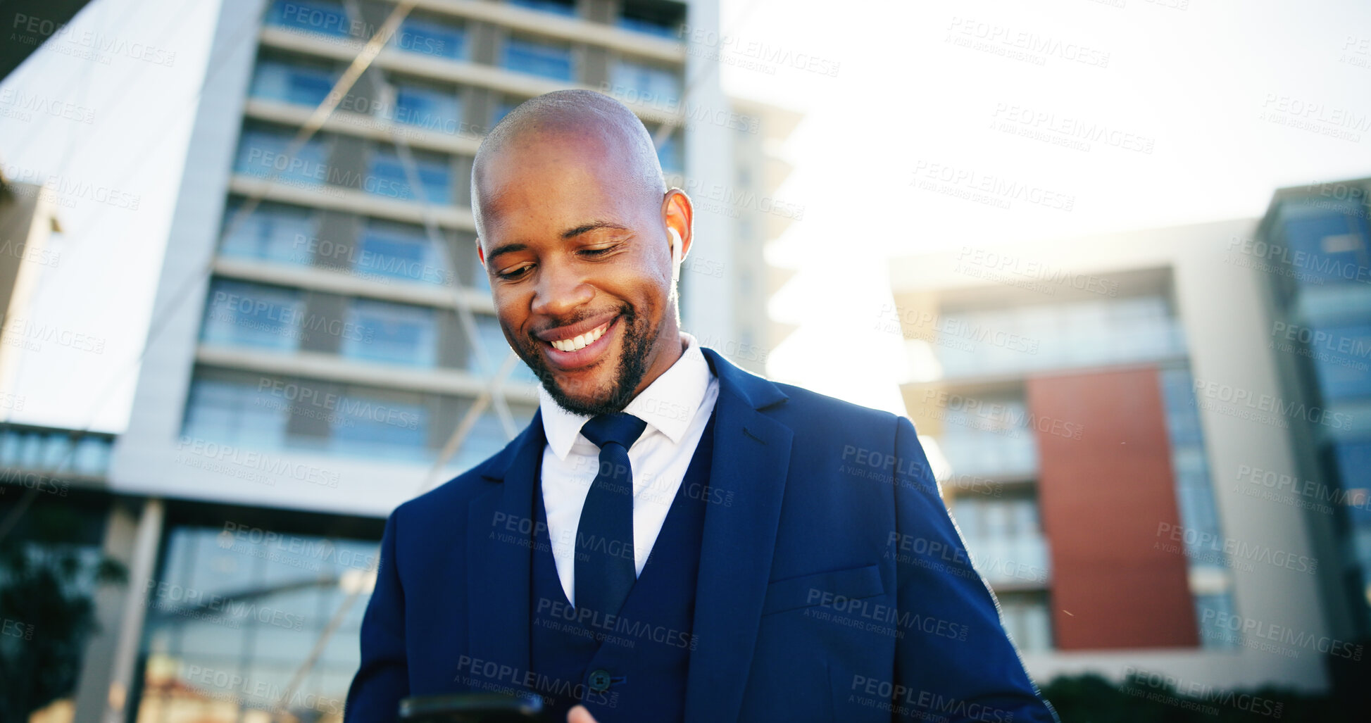 Buy stock photo Happy, phone and black businessman in city for text, networking and online message. Corporate, professional and African entrepreneur with smile for mobile app, internet news or email in urban town