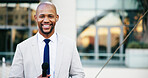 Portrait, microphone and black man in city, presenter and news reporter with smile, confidence and pride. African person, outdoor and journalist in street, live broadcasting and media personality