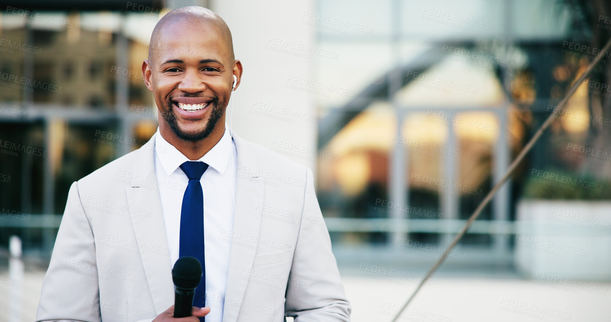 Buy stock photo Portrait, microphone and black man in city, presenter and news reporter with smile, confidence and pride. African person, outdoor and journalist in street, live broadcasting and media personality