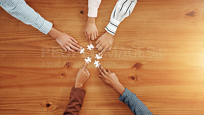 Buy stock photo Hands, puzzle and business people in office for partnership, solution or collaboration in meeting. Jigsaw, top view and corporate employees with synergy, problem solving or team building by space.