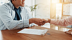 Contract, business people and interview with handshake for hiring, meeting or agreement together at office. Shaking hands, man and smile with paperwork for b2b deal, recruiting or partnership