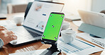 Phone, green screen and person in office for research, finance report and business performance. Mockup space, hand and laptop for financial planning, tax information and investment proposal graphs