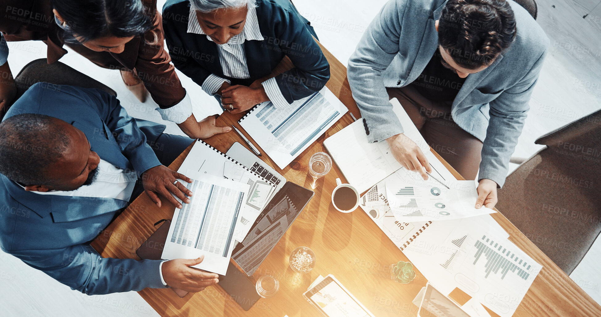 Buy stock photo Business people, team and above with documents, financial review, group and graphs at office. Men, women and paperwork with laptop, charts and meeting with feedback for collaboration at company