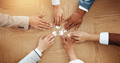 Buy stock photo Hands, above and puzzle for team at office with solution, synergy and strategy for game at company. Group, jigsaw and problem solving with integration, challenge and collaboration at insurance agency