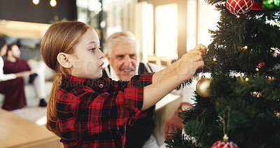 Buy stock photo Christmas, grandpa or child with tree ornament for festive decoration, tradition or christian home. Hang, ball or girl in house with elderly person, kid or senior man for holiday, trinket or love