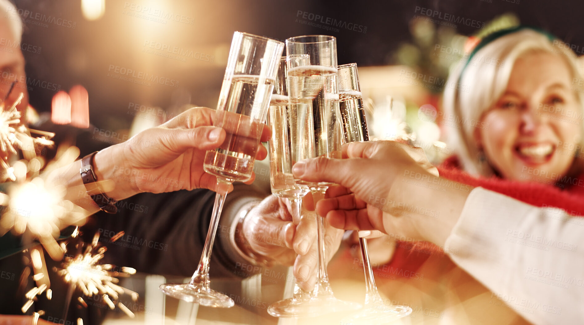 Buy stock photo Happy family, hands and cheers with champagne glasses for thanksgiving dinner, toast or home feast. People, alcohol or drink with sparklers for dining celebration, festive holiday or christmas party