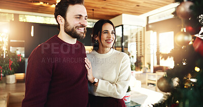 Buy stock photo Christmas, couple and smile for celebration, home and romance in festive season, decoration or tree. Happy, man and bonding with woman on holiday, December or love on weekend in house or relationship