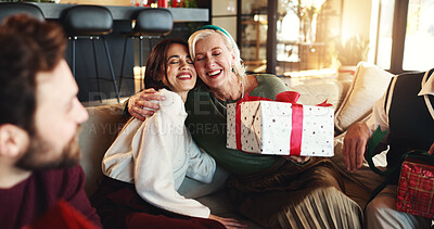 Buy stock photo Hug, Christmas gift and woman with senior parent for vacation, bonding and excited. December, holiday or festive surprise with family, present and celebration with smile and social gathering in home