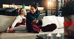 Christmas, happy mom and kid with tablet in home for holiday, love and care. Xmas, parent and girl child with tech in living room for festive season, relax and family bonding together with daughter