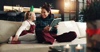 Buy stock photo Christmas, happy mom and kid with tablet in home for holiday, love and care. Xmas, parent and girl child with tech in living room for festive season, relax and family bonding together with daughter
