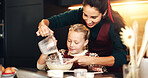 Milk, mother and child baking for learning, help and bonding in home kitchen. Happy parent, kid and cooking with flour, pour dairy and teaching recipe to girl with ingredients for dessert with family